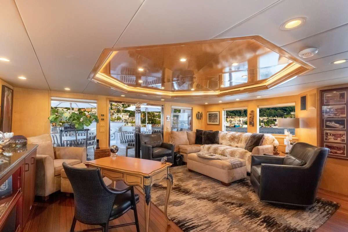 a living room with leather couches and a table aboard LONE STAR Yacht for Sale