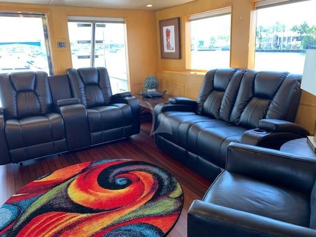 a living room with leather couches aboard LONE STAR Yacht for Sale