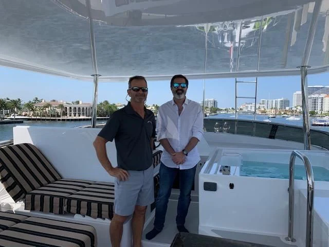 a couple of men standing on a boat aboard LONE STAR Yacht for Sale