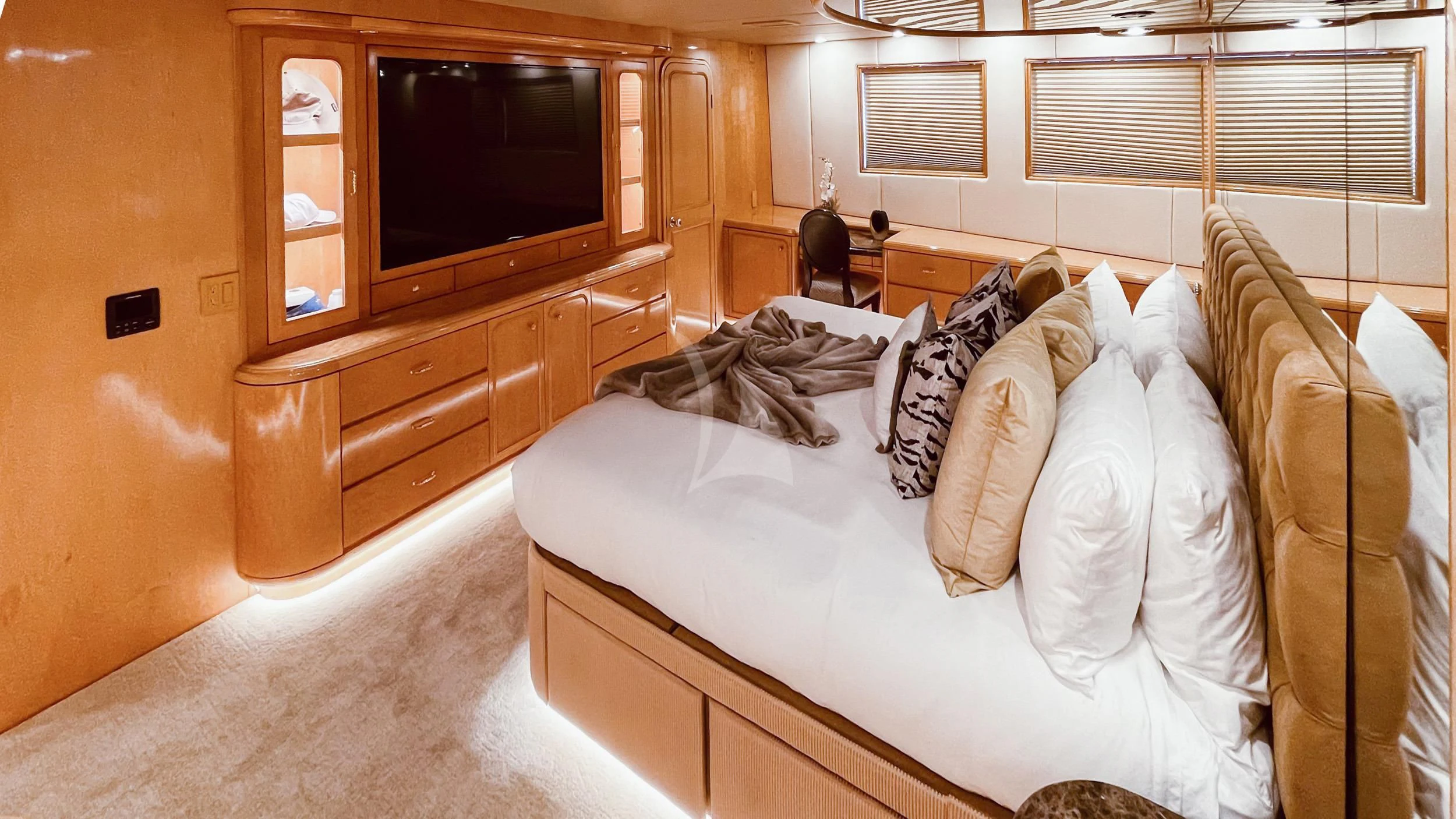 a bed with pillows and a television aboard LONE STAR Yacht for Sale