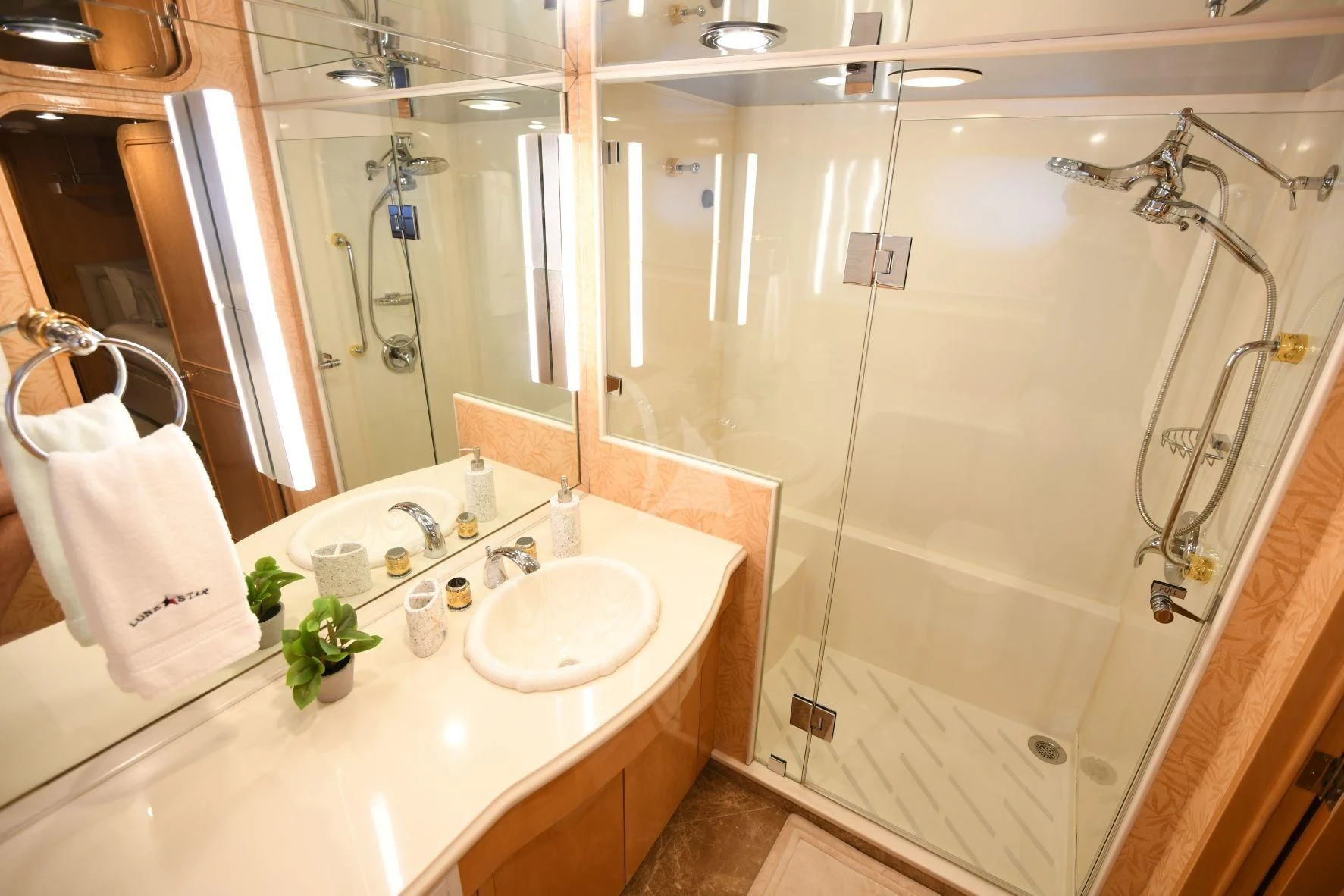 a bathroom with a shower sink and a mirror aboard LONE STAR Yacht for Sale