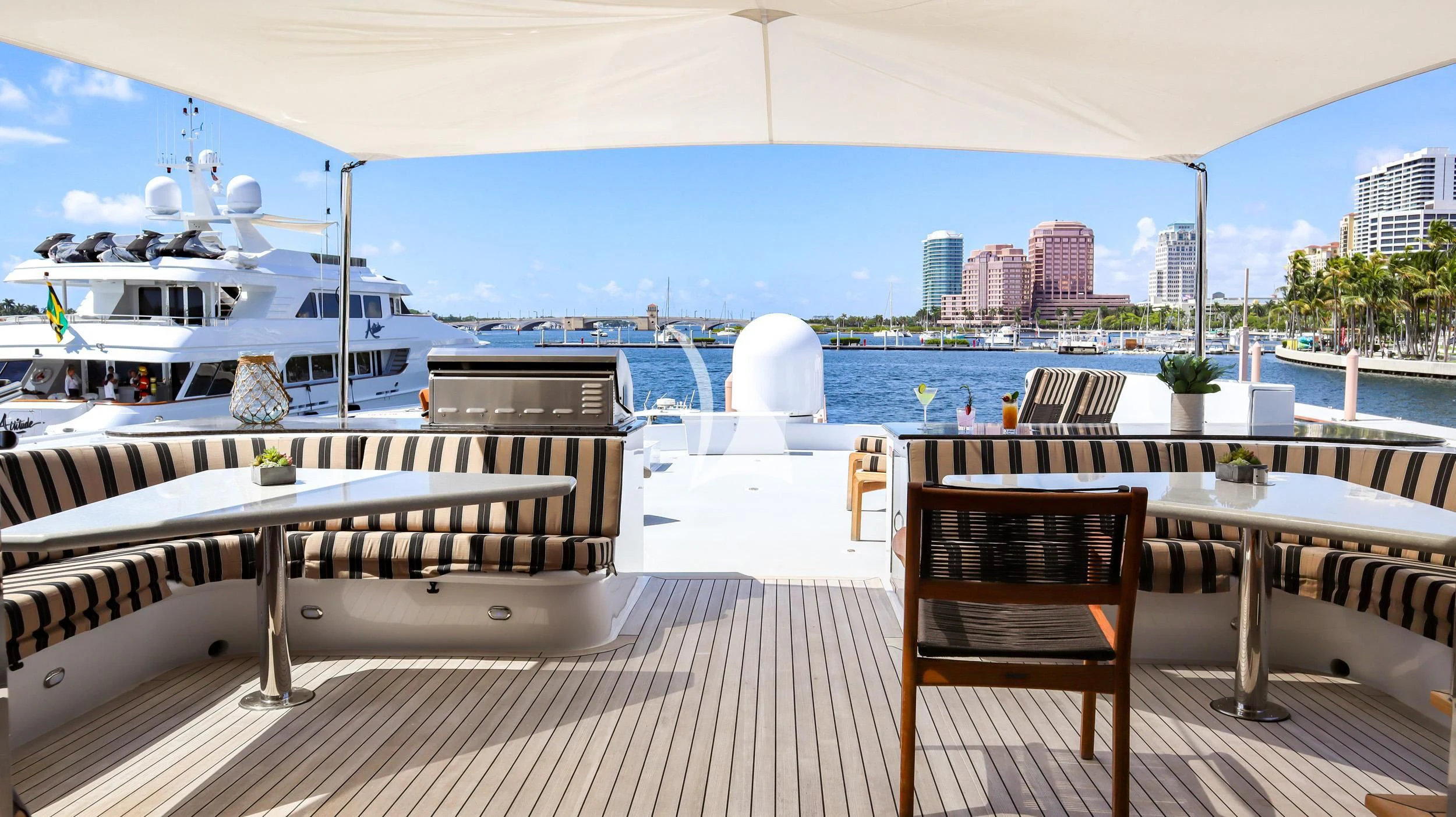 a deck with a large body of water and a large ship in the background aboard LONE STAR Yacht for Sale