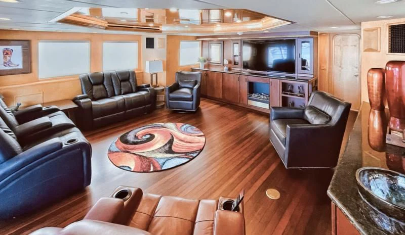 a living room with leather furniture aboard LONE STAR Yacht for Sale