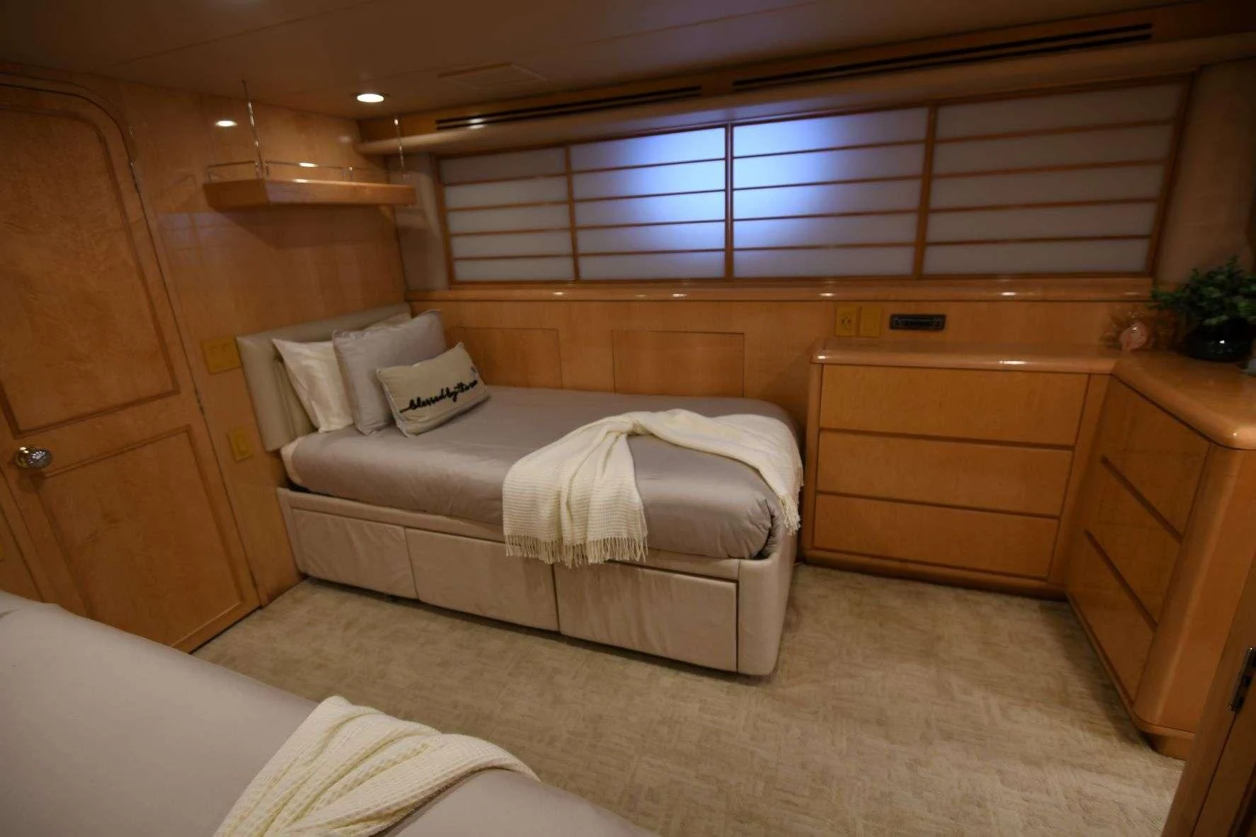 a room with a bed and a dresser aboard LONE STAR Yacht for Sale