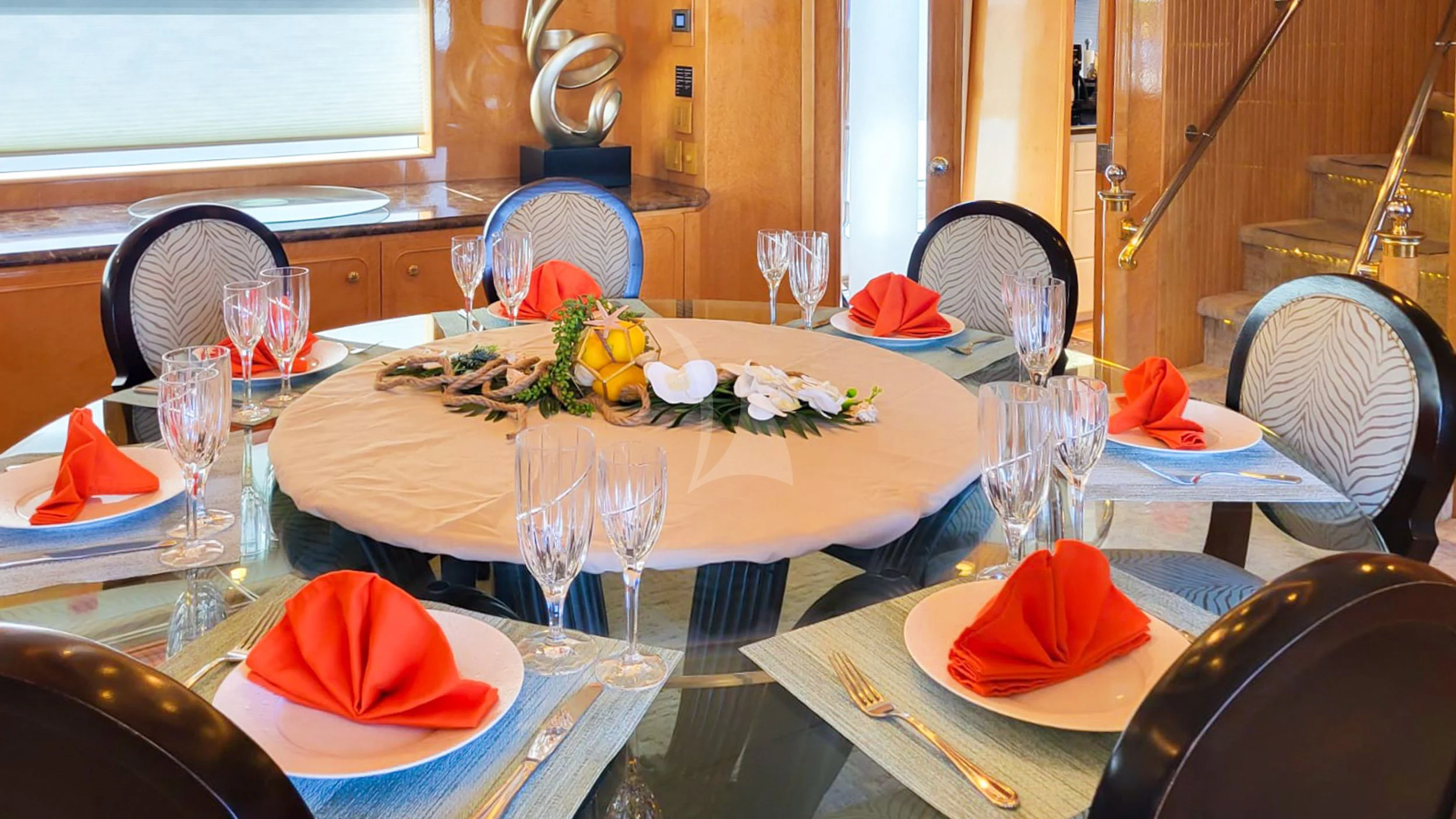 a table with glasses and plates aboard LONE STAR Yacht for Sale