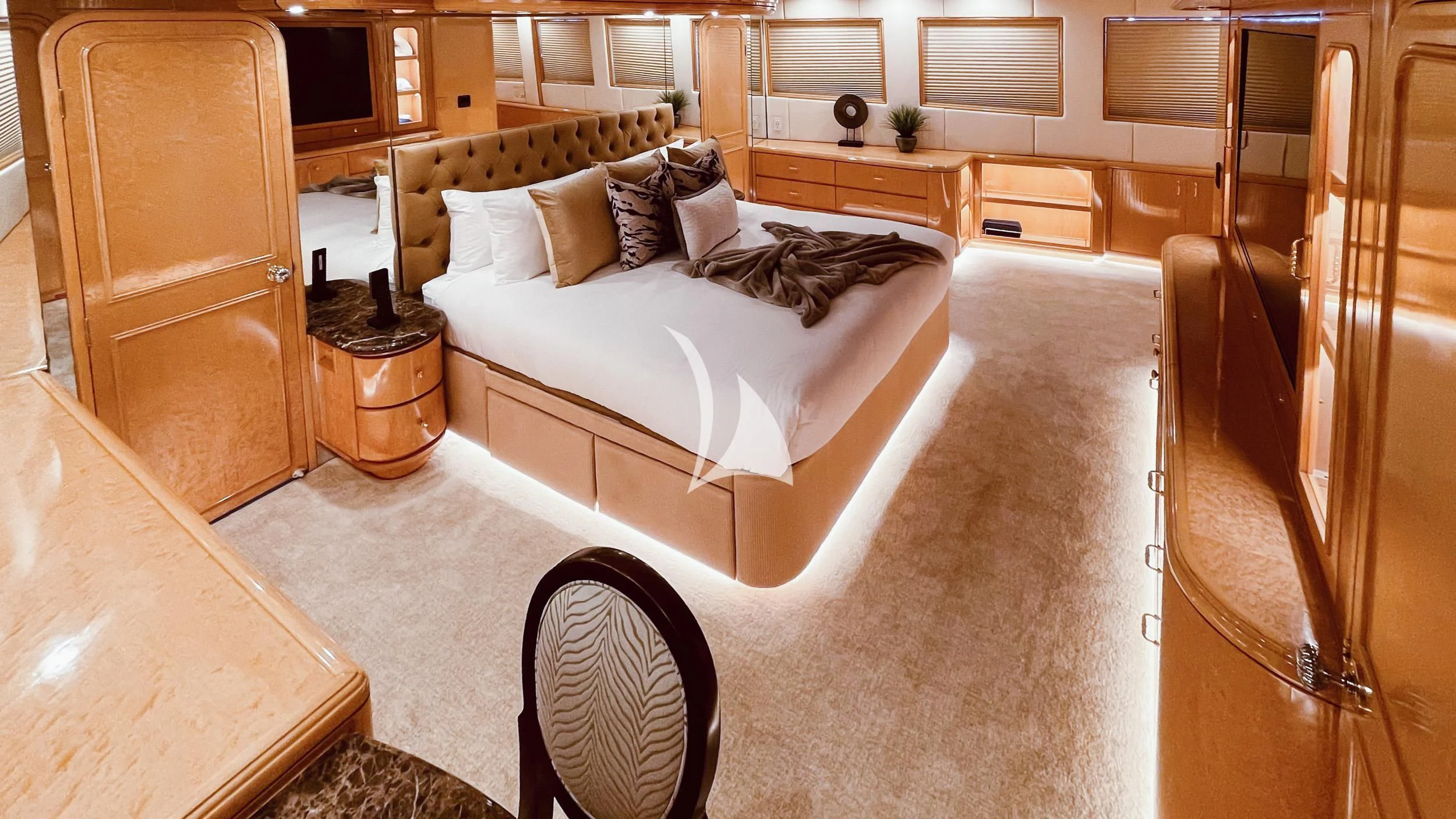 a bedroom with a bed and a chair aboard LONE STAR Yacht for Sale
