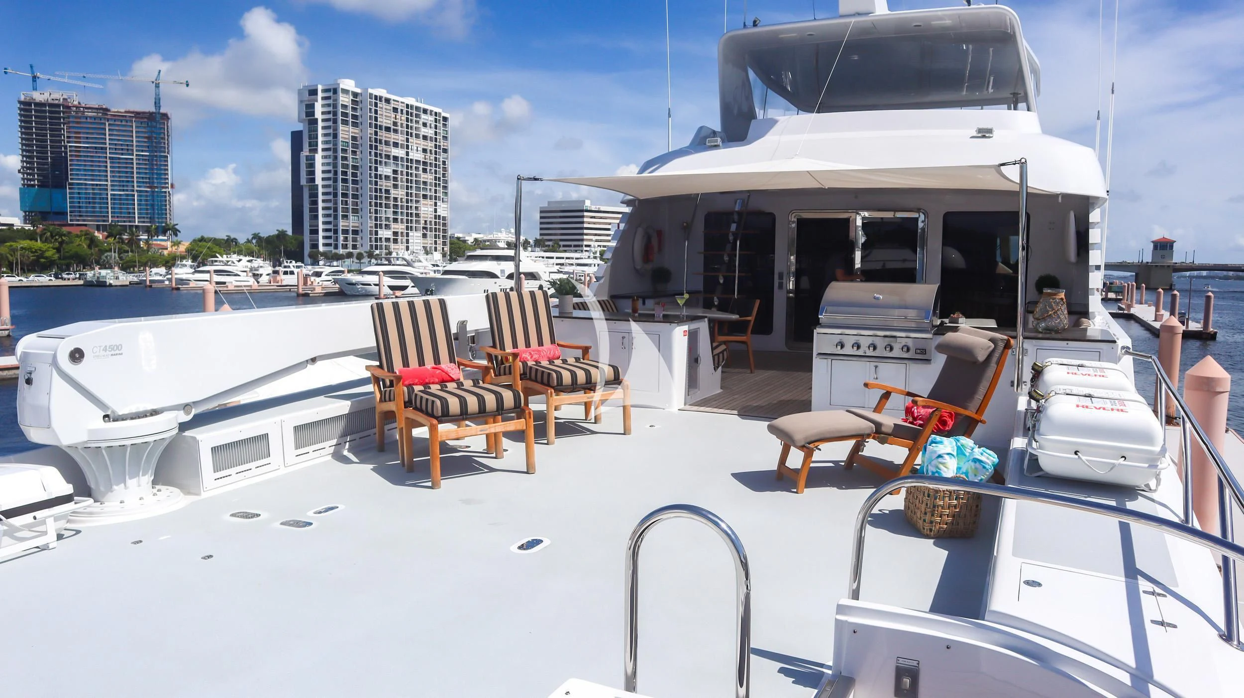 a white boat with chairs around it aboard LONE STAR Yacht for Sale