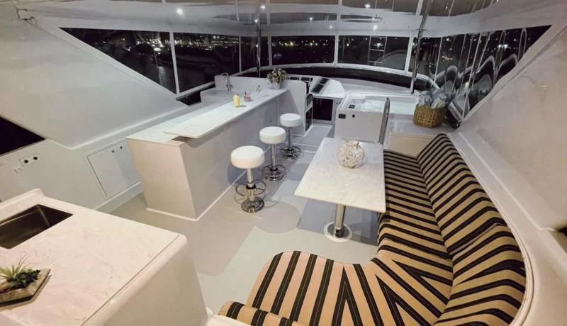 a room with white walls and black and white flooring aboard LONE STAR Yacht for Sale
