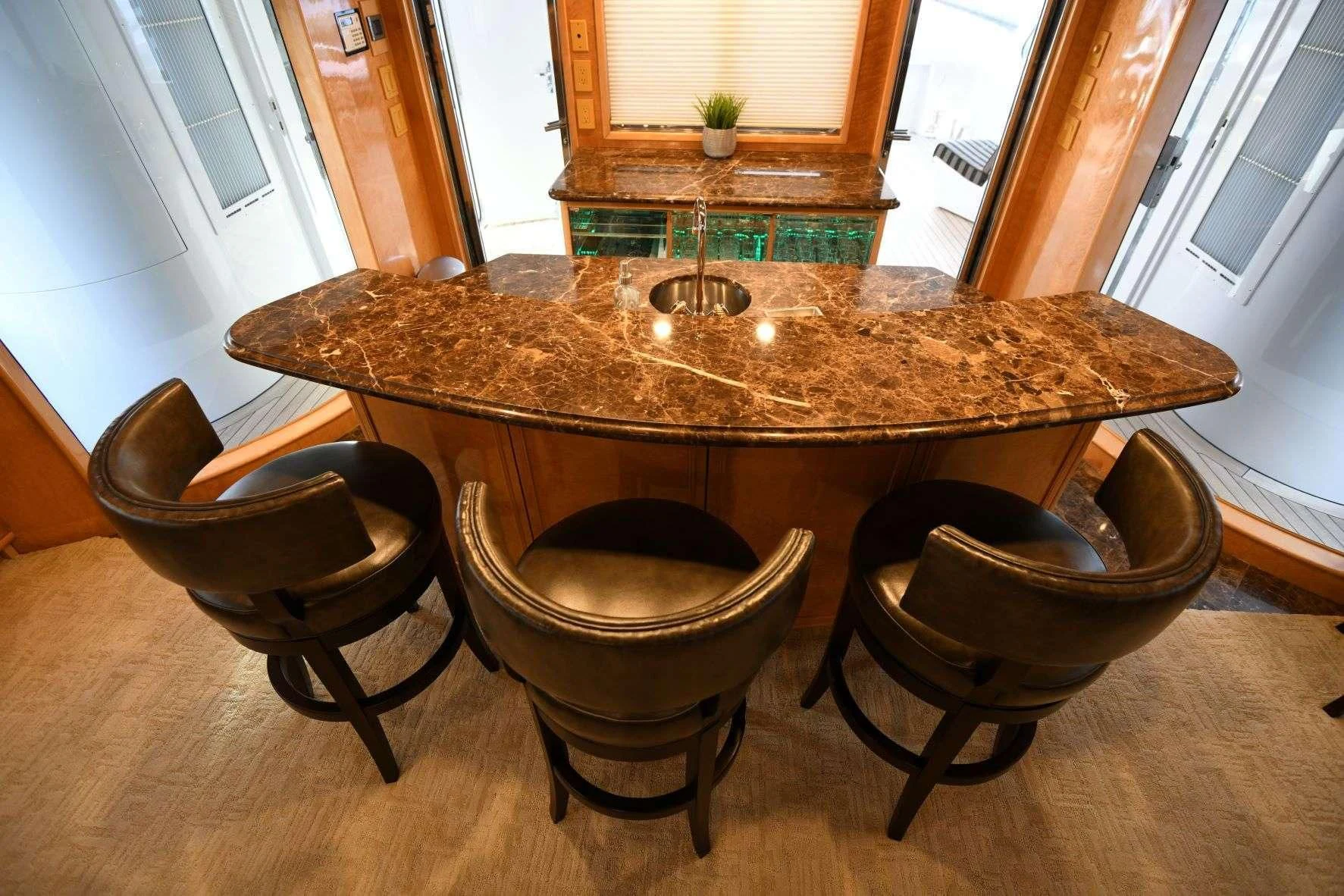 a table with chairs around it aboard LONE STAR Yacht for Sale