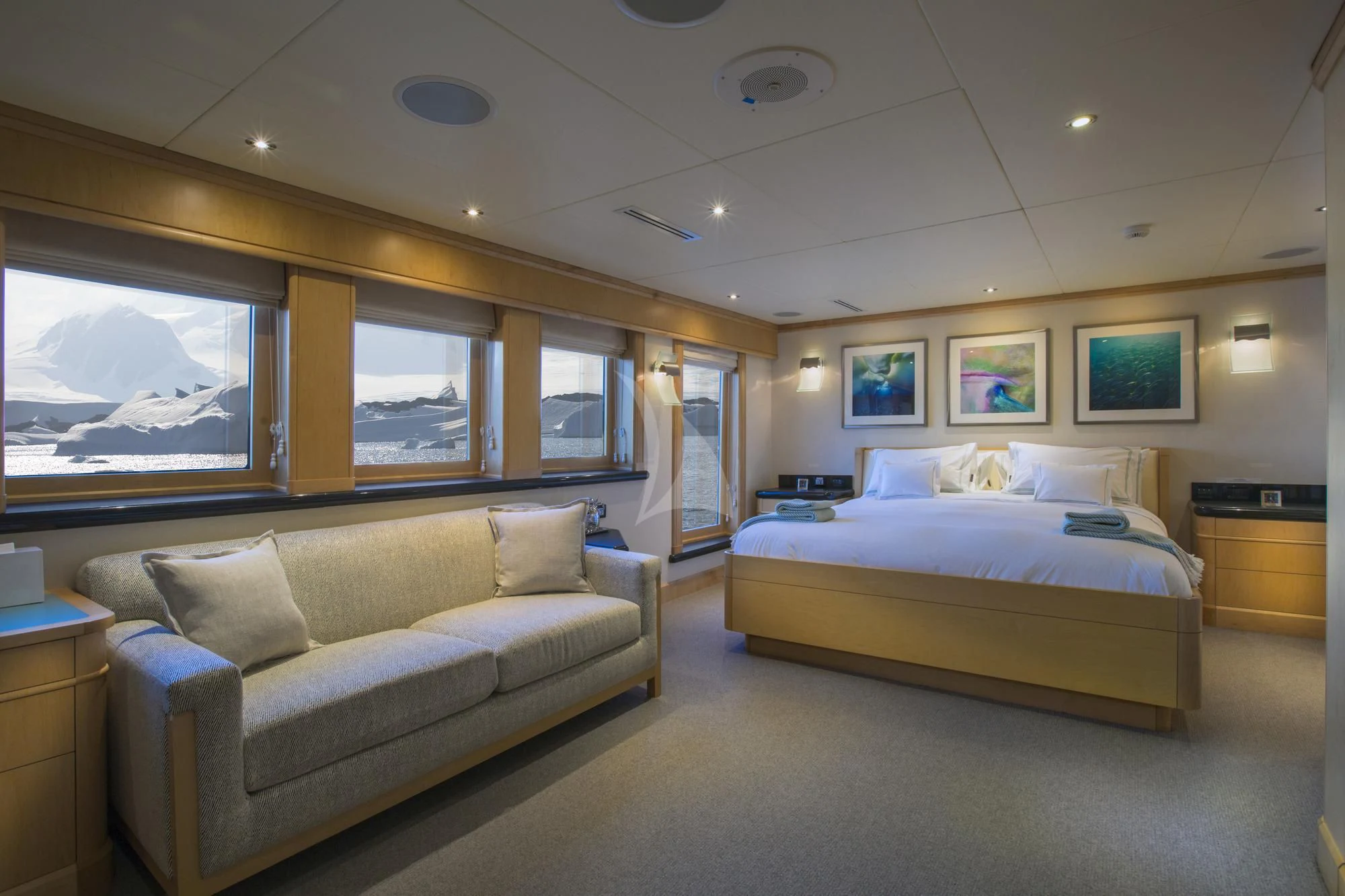 a bedroom with a bed and a couch aboard HYDRA Yacht for Sale