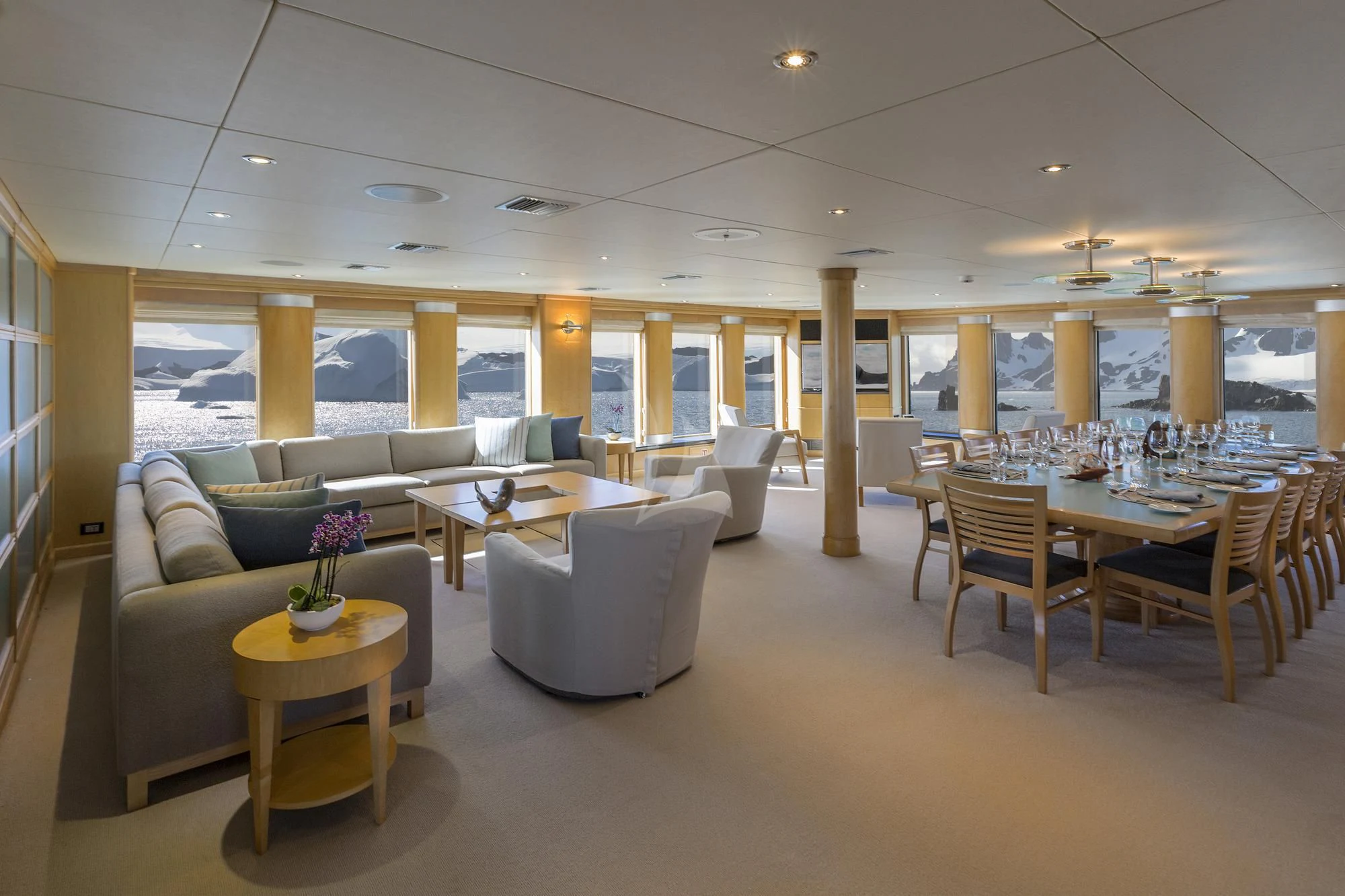 a room with a table chairs and a couch aboard HYDRA Yacht for Sale