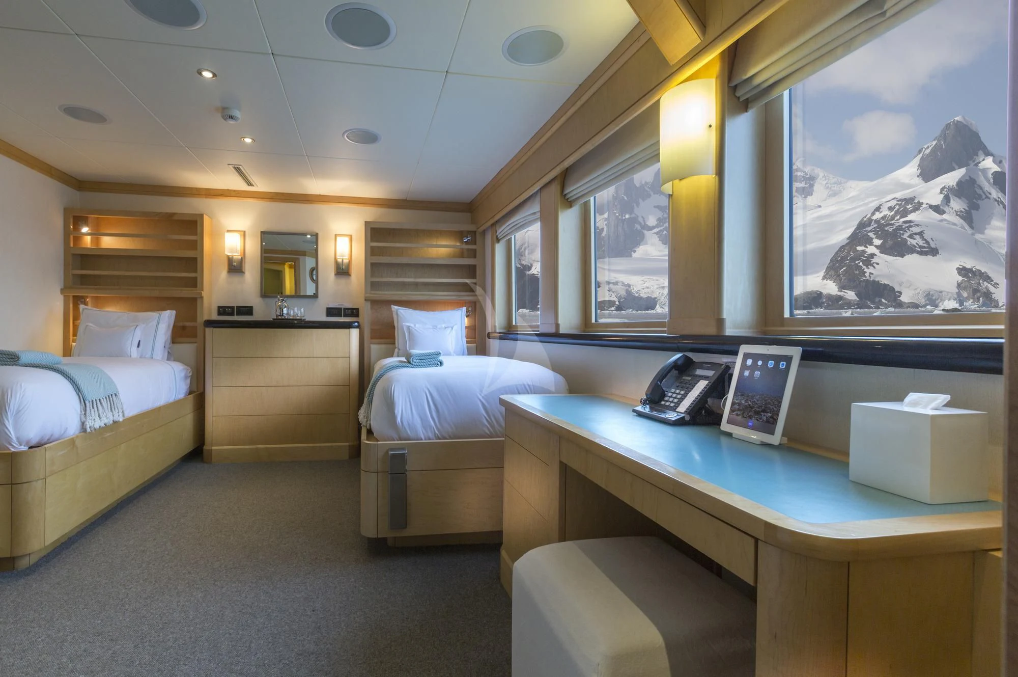 a room with a desk and a bed aboard HYDRA Yacht for Sale