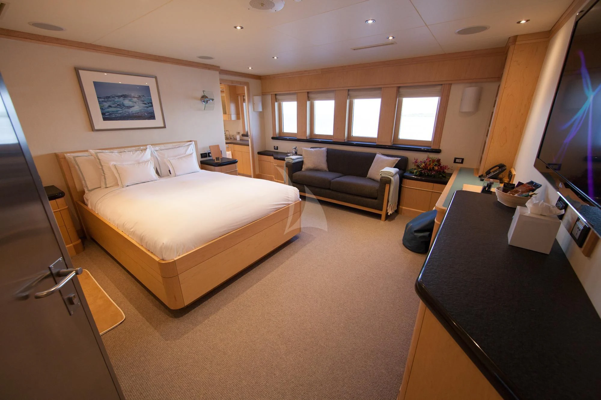 a bedroom with a bed and a tv aboard HYDRA Yacht for Sale