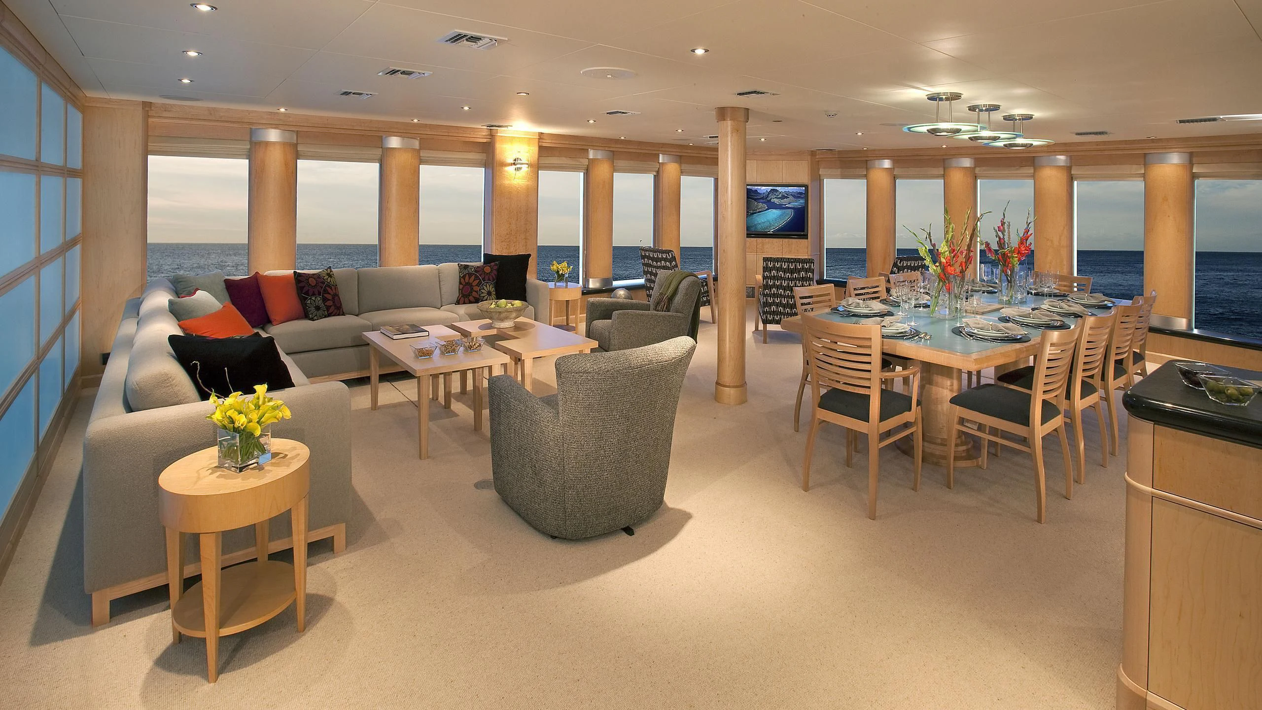 a living room with a table and chairs aboard HYDRA Yacht for Sale