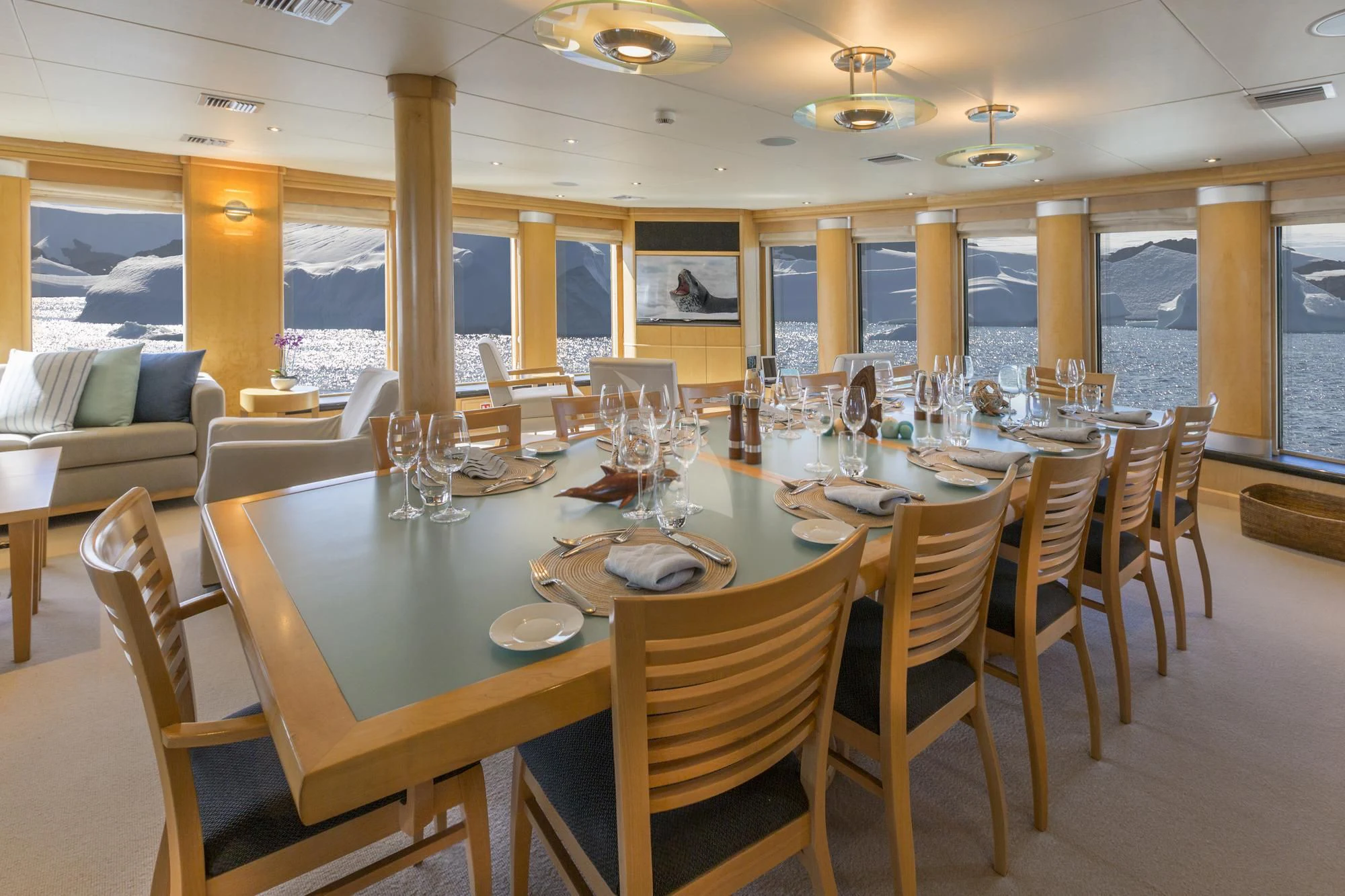 a large dining table with chairs aboard HYDRA Yacht for Sale