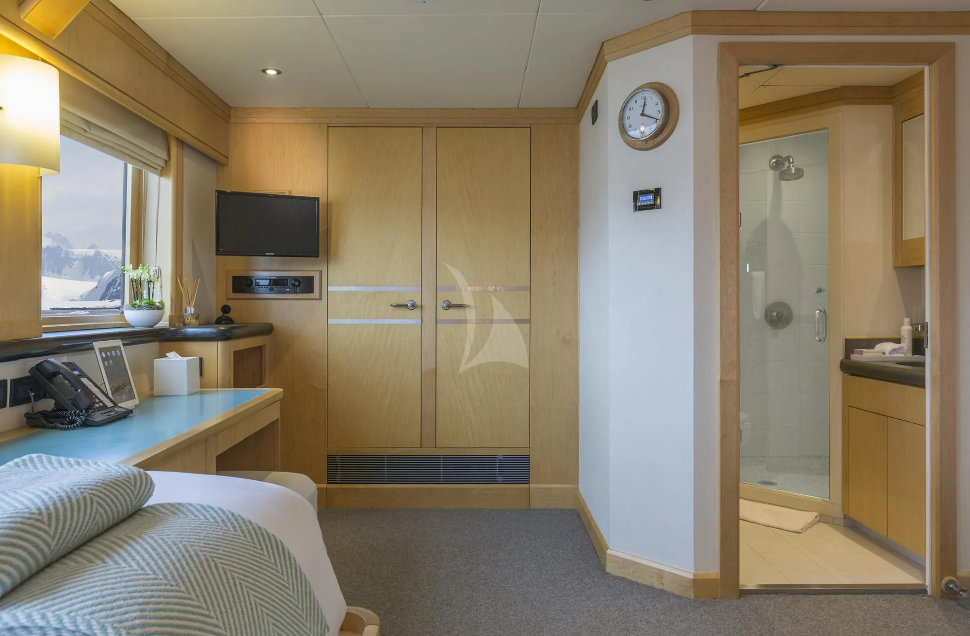 a room with a bed and a tv aboard HYDRA Yacht for Sale
