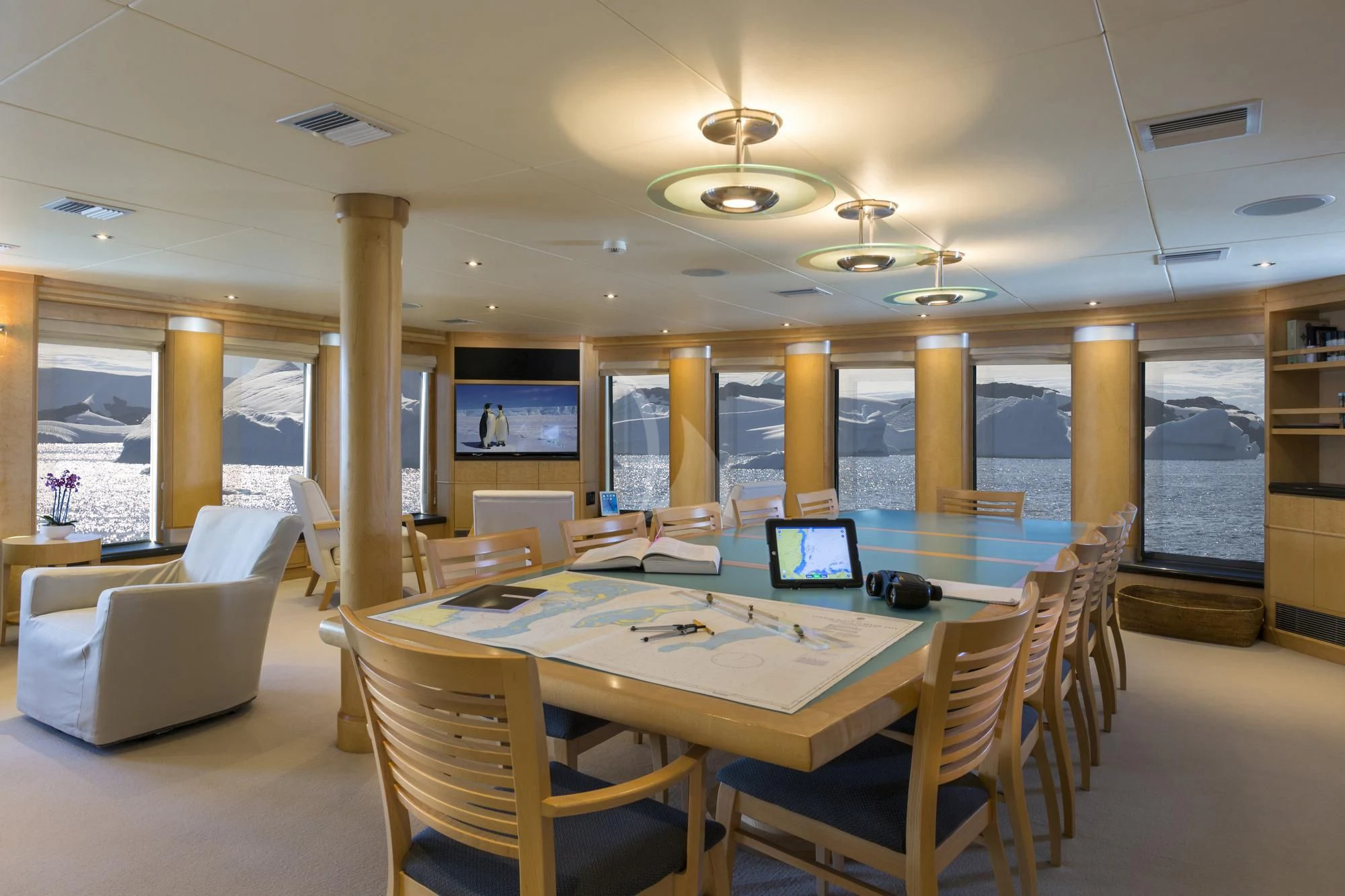 a room with a table and chairs aboard HYDRA Yacht for Sale