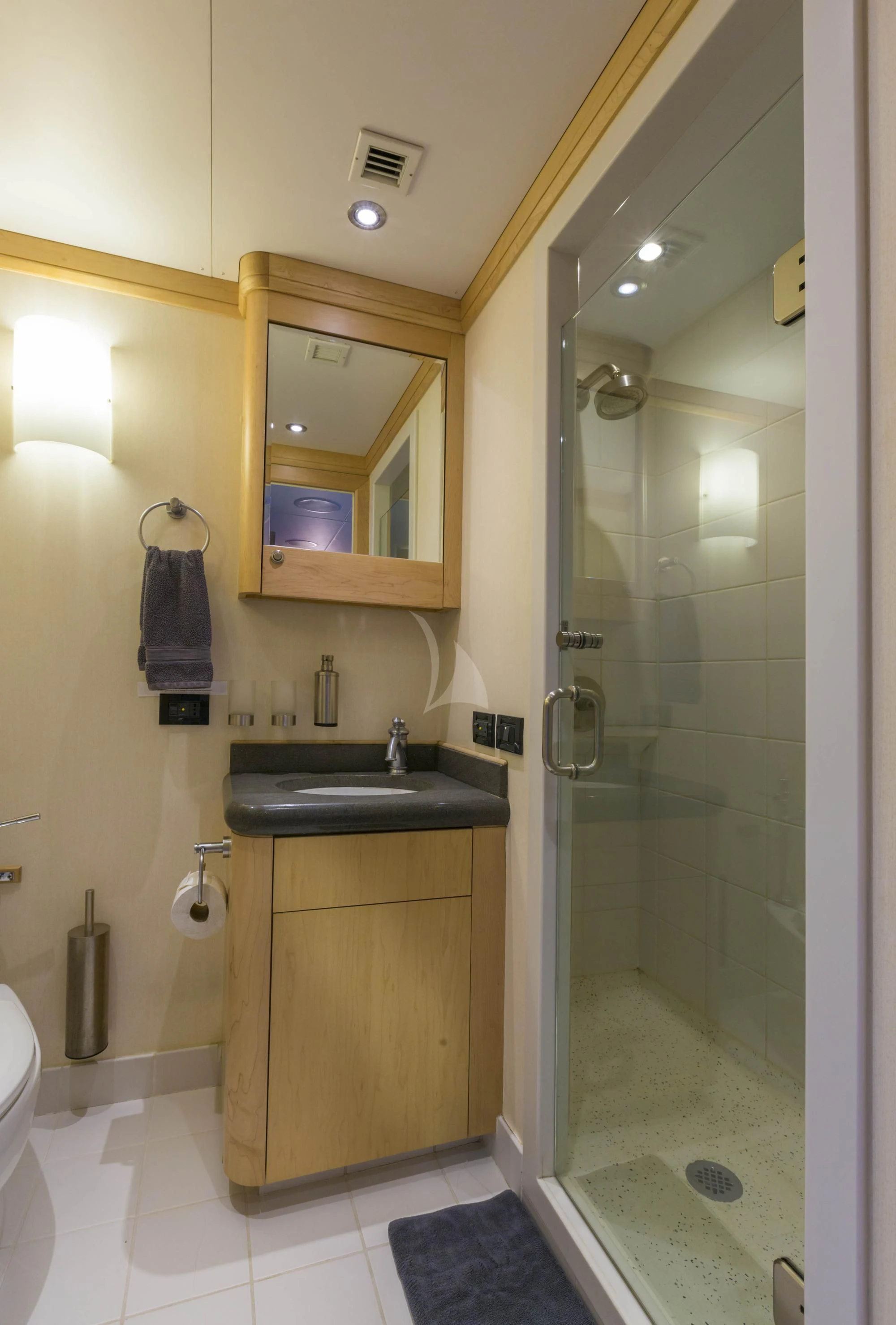 a bathroom with a glass shower door aboard HYDRA Yacht for Sale