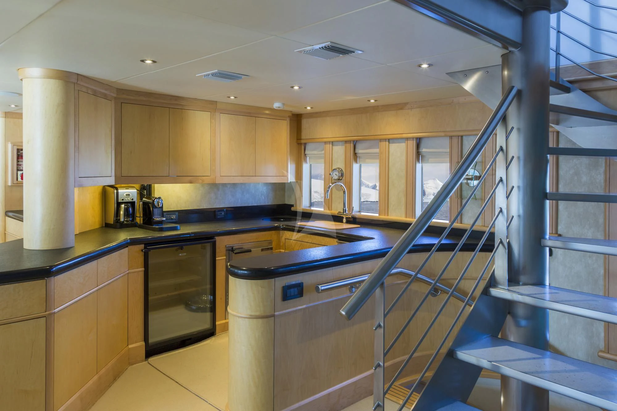 a kitchen with a steel stove aboard HYDRA Yacht for Sale