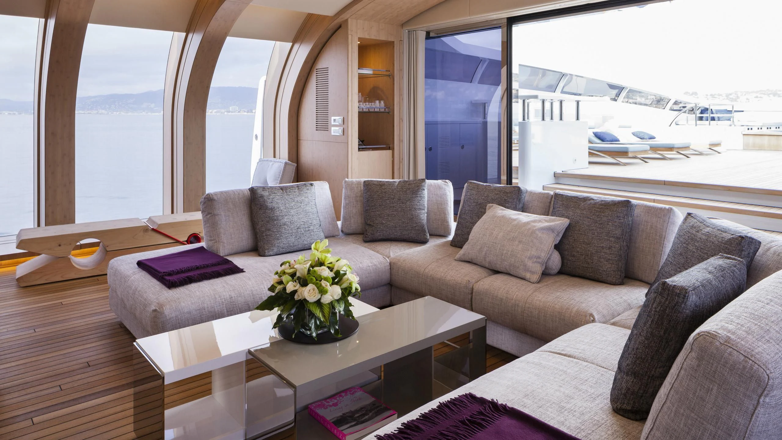 a living room with a large window aboard CRAZY ME Yacht for Sale