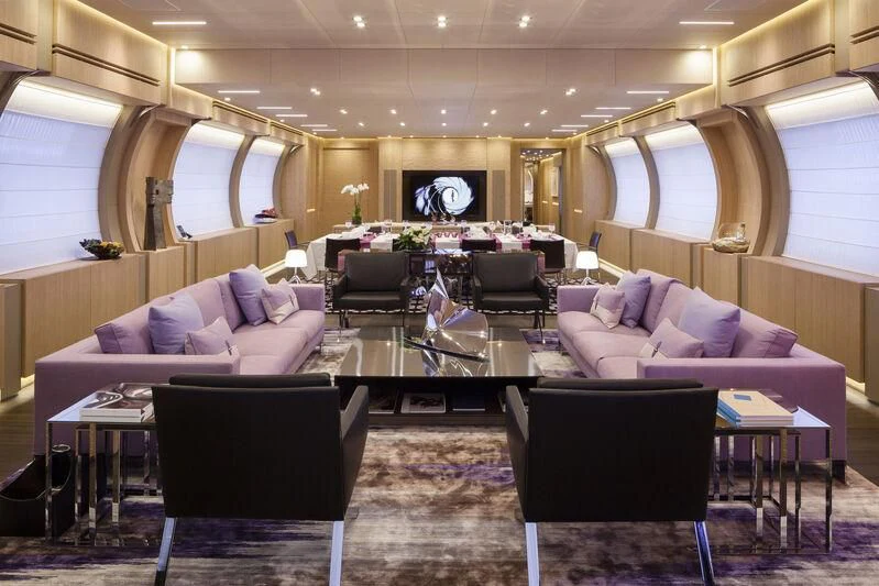 a large living room with a table and chairs aboard CRAZY ME Yacht for Sale
