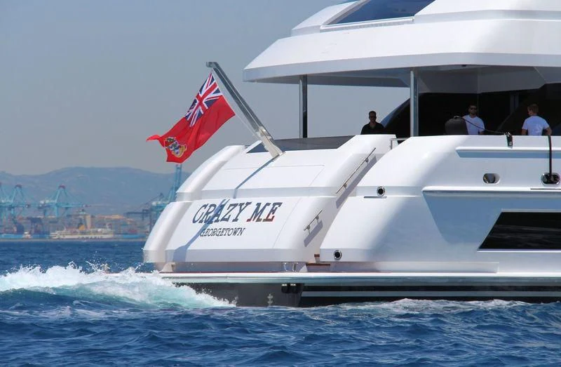 a boat with a flag on it aboard CRAZY ME Yacht for Sale