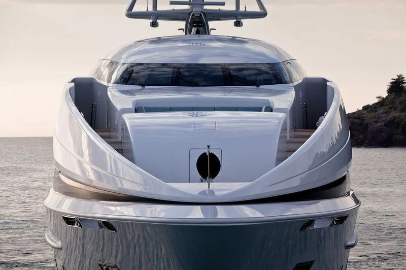 a white car with a large spoiler on a beach aboard CRAZY ME Yacht for Sale