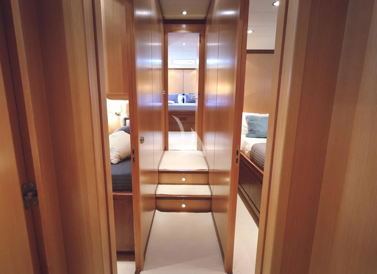 a room with a bed and a door aboard BRAVO DELTA Yacht for Sale