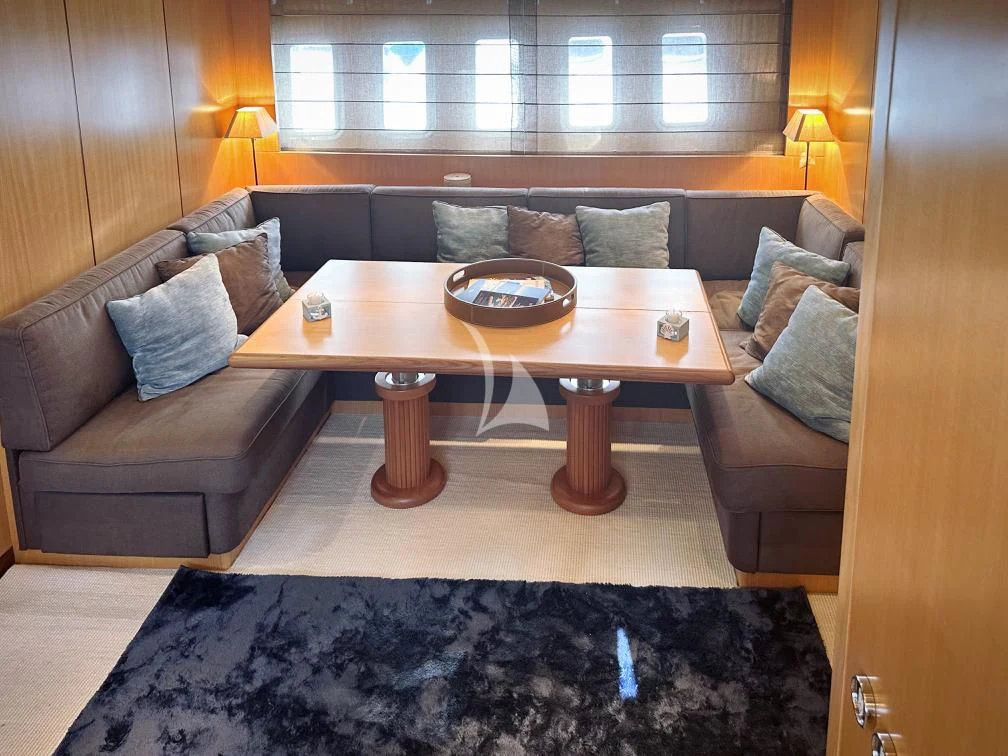 a living room with a couch and a coffee table aboard BRAVO DELTA Yacht for Sale