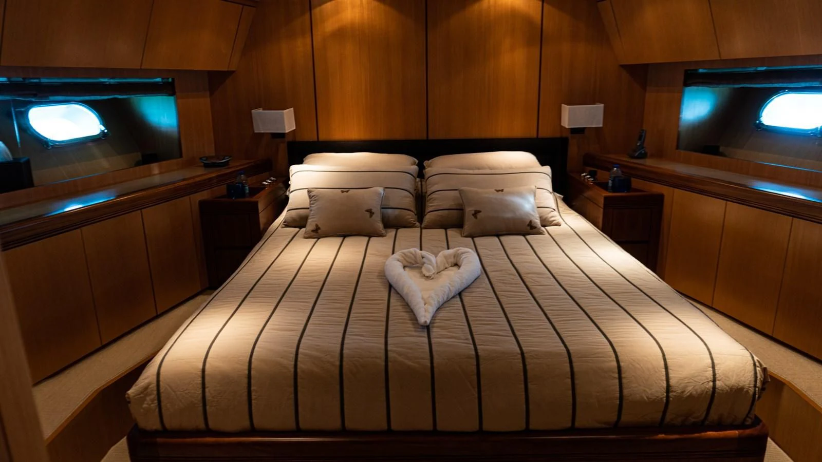 a bed with a white blanket on it aboard BRAVO DELTA Yacht for Sale