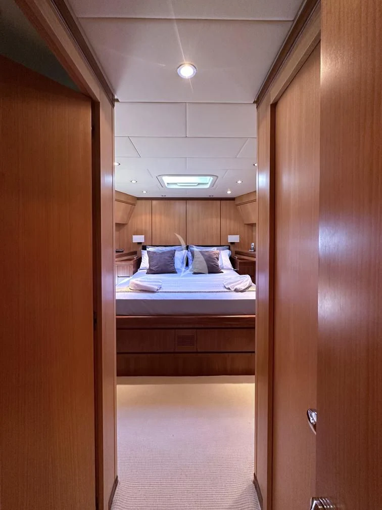a room with a bed and a door aboard BRAVO DELTA Yacht for Sale