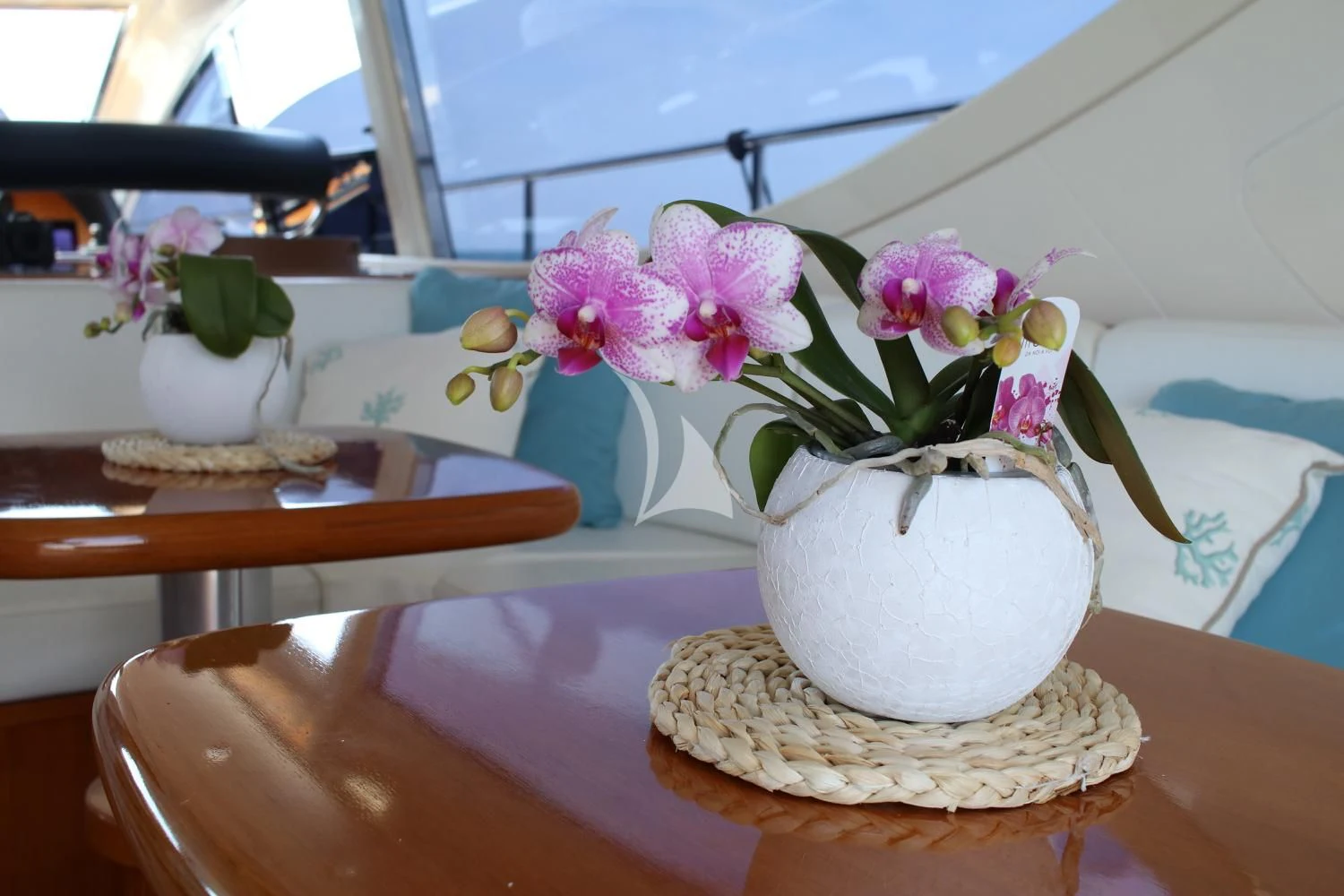 a vase of flowers on a table aboard BRAVO DELTA Yacht for Sale