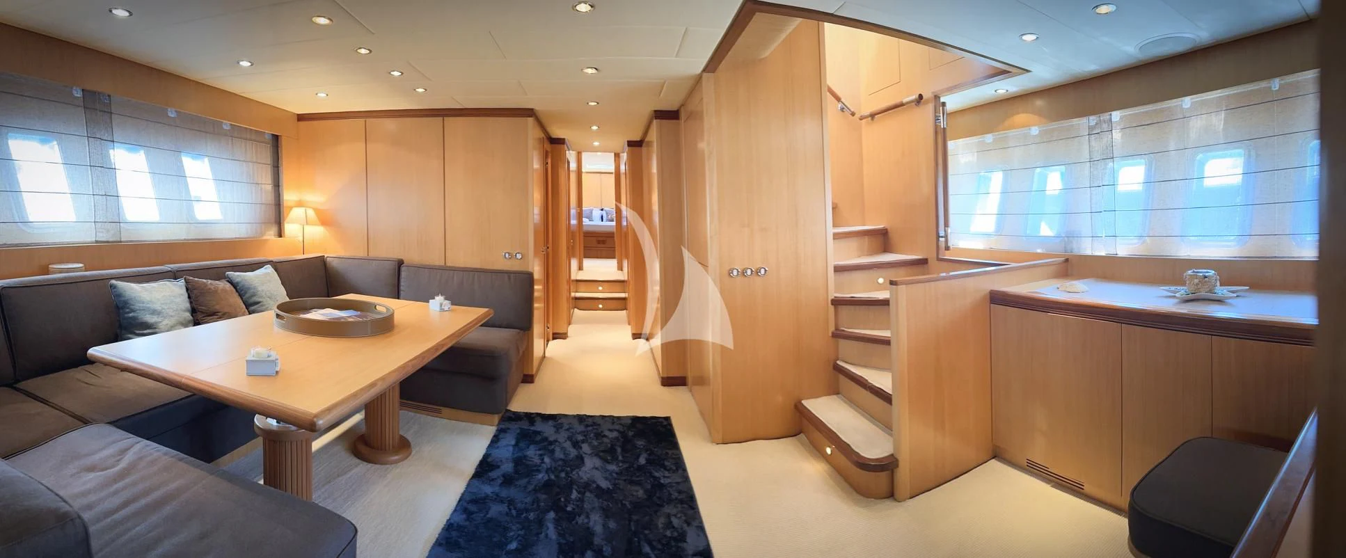 a room with a couch and a table aboard BRAVO DELTA Yacht for Sale
