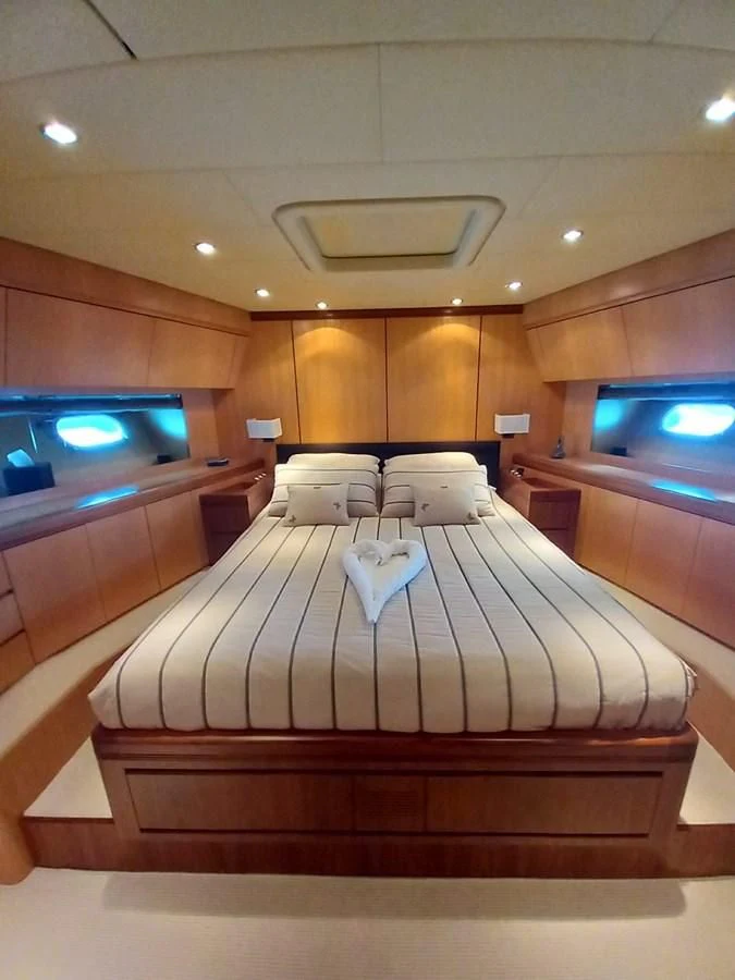 a room with a bed and a television aboard BRAVO DELTA Yacht for Sale