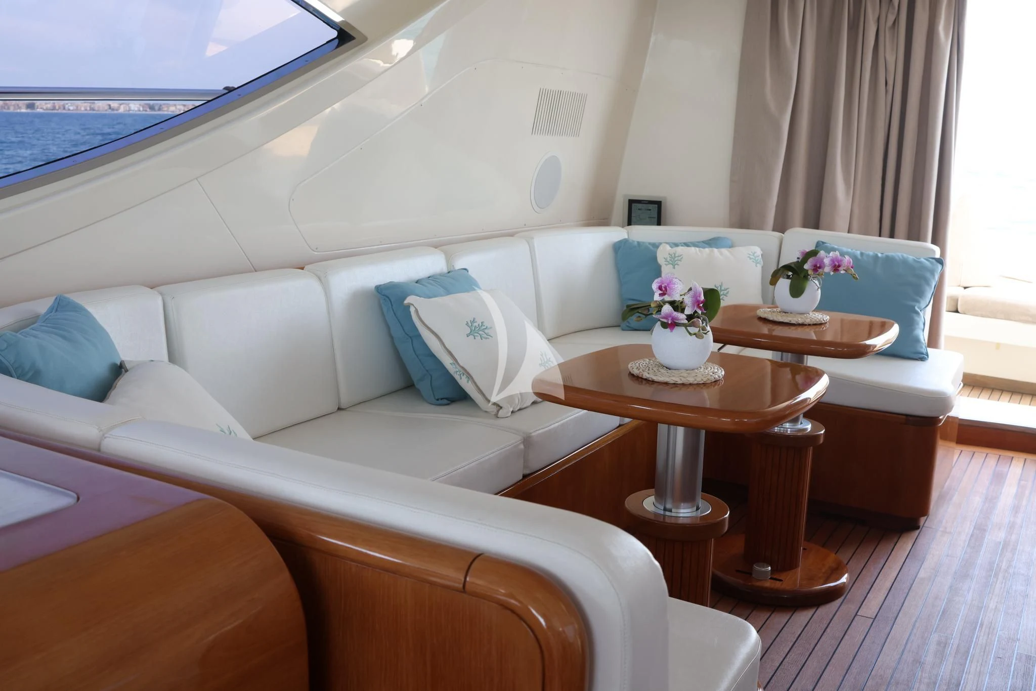 a white couch with a coffee table aboard BRAVO DELTA Yacht for Sale