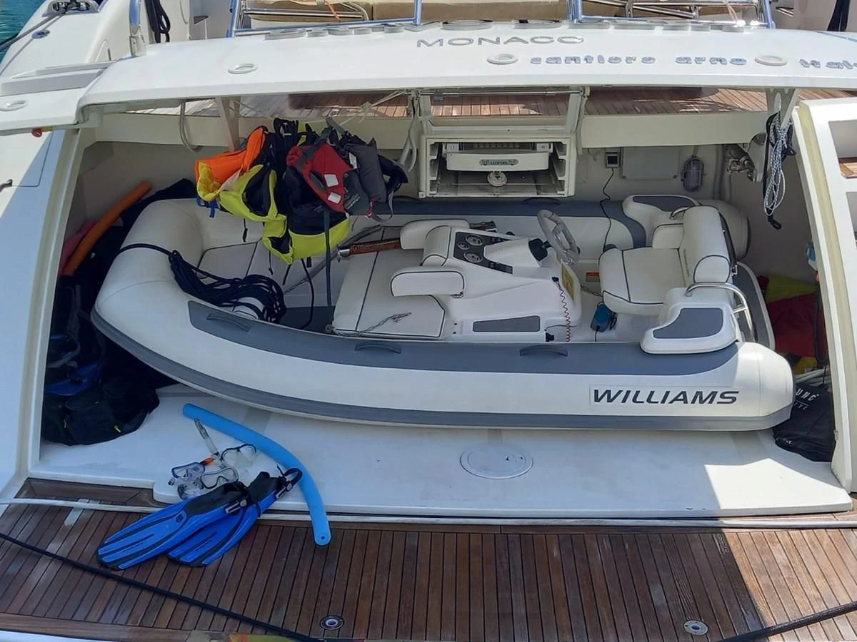 a white boat with a blue and yellow rope attached to it aboard BRAVO DELTA Yacht for Sale