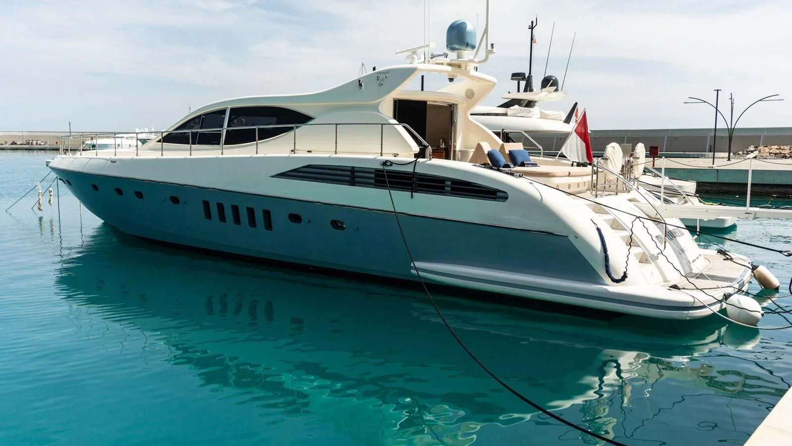 a white yacht in a harbor aboard BRAVO DELTA Yacht for Sale