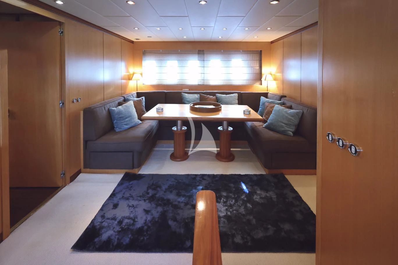 a living room with a couch and a table aboard BRAVO DELTA Yacht for Sale