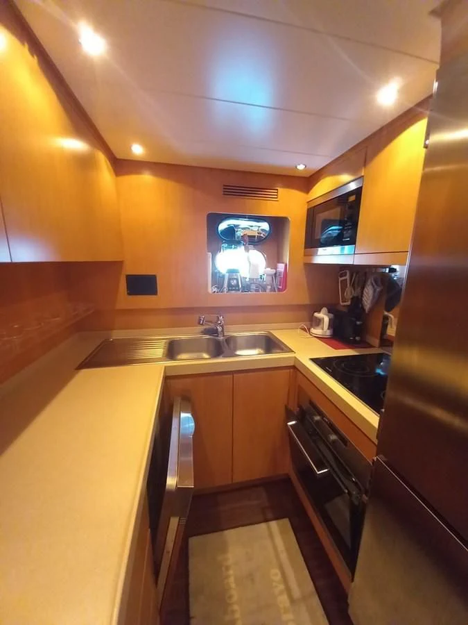 a kitchen with a tv on the wall aboard BRAVO DELTA Yacht for Sale