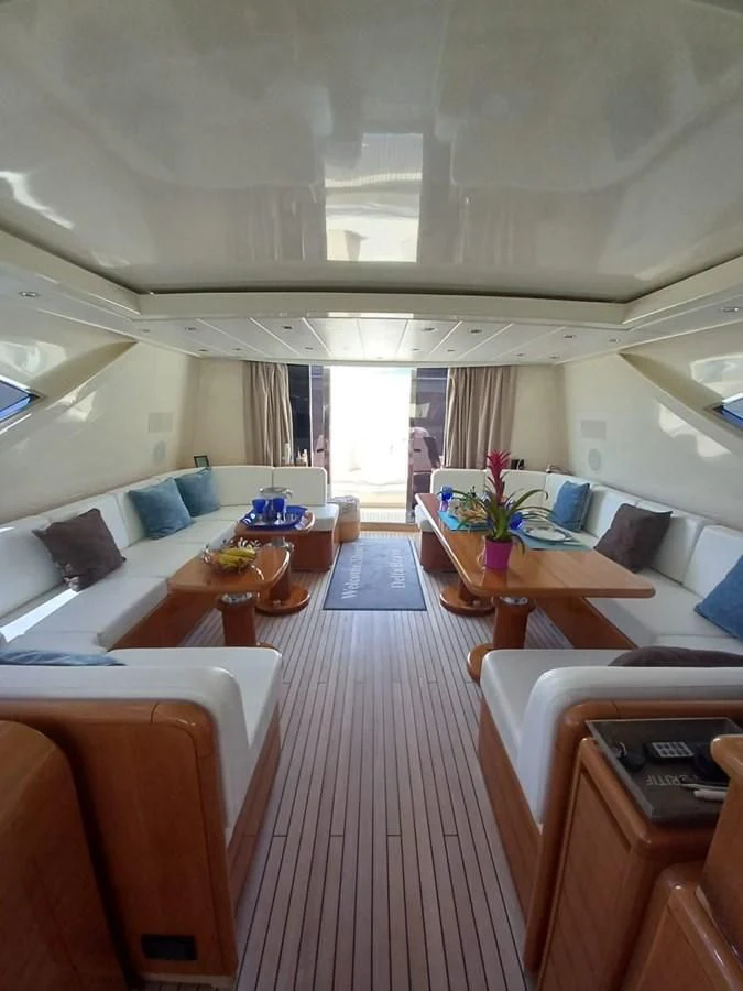 a room with a couch and a table and chairs aboard BRAVO DELTA Yacht for Sale