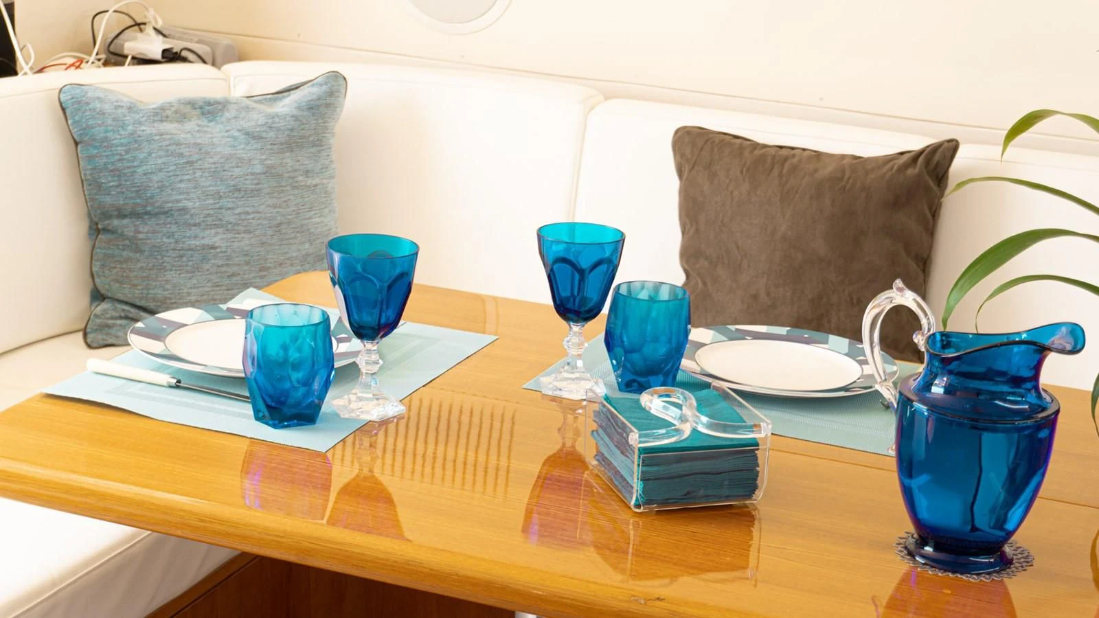 a table with blue glasses and a tray of blue cups on it aboard BRAVO DELTA Yacht for Sale