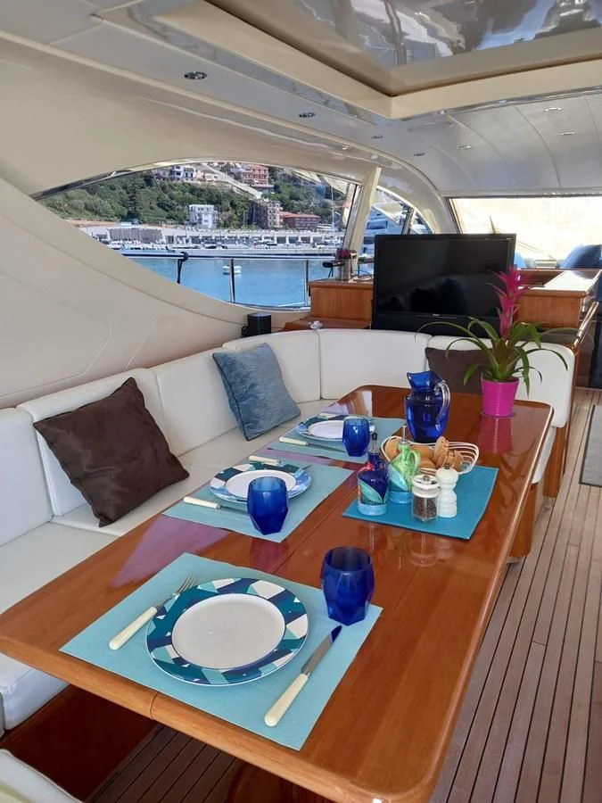 a table with plates and cups on it aboard BRAVO DELTA Yacht for Sale