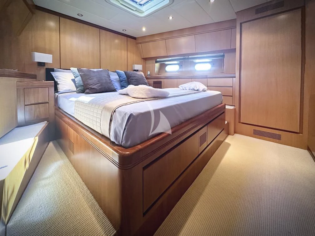 a room with a bed and a desk aboard BRAVO DELTA Yacht for Sale