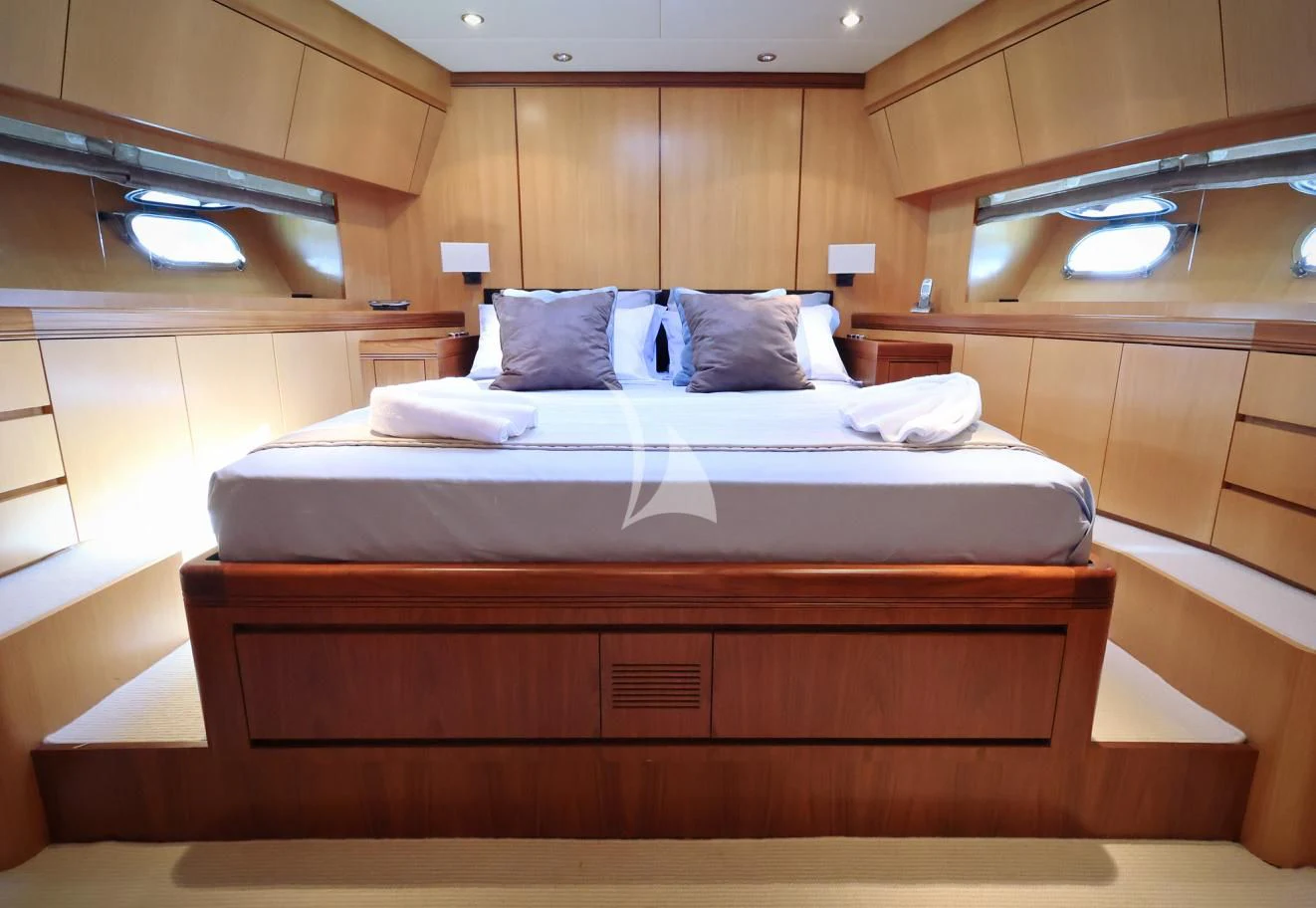 a bed with a wooden headboard aboard BRAVO DELTA Yacht for Sale