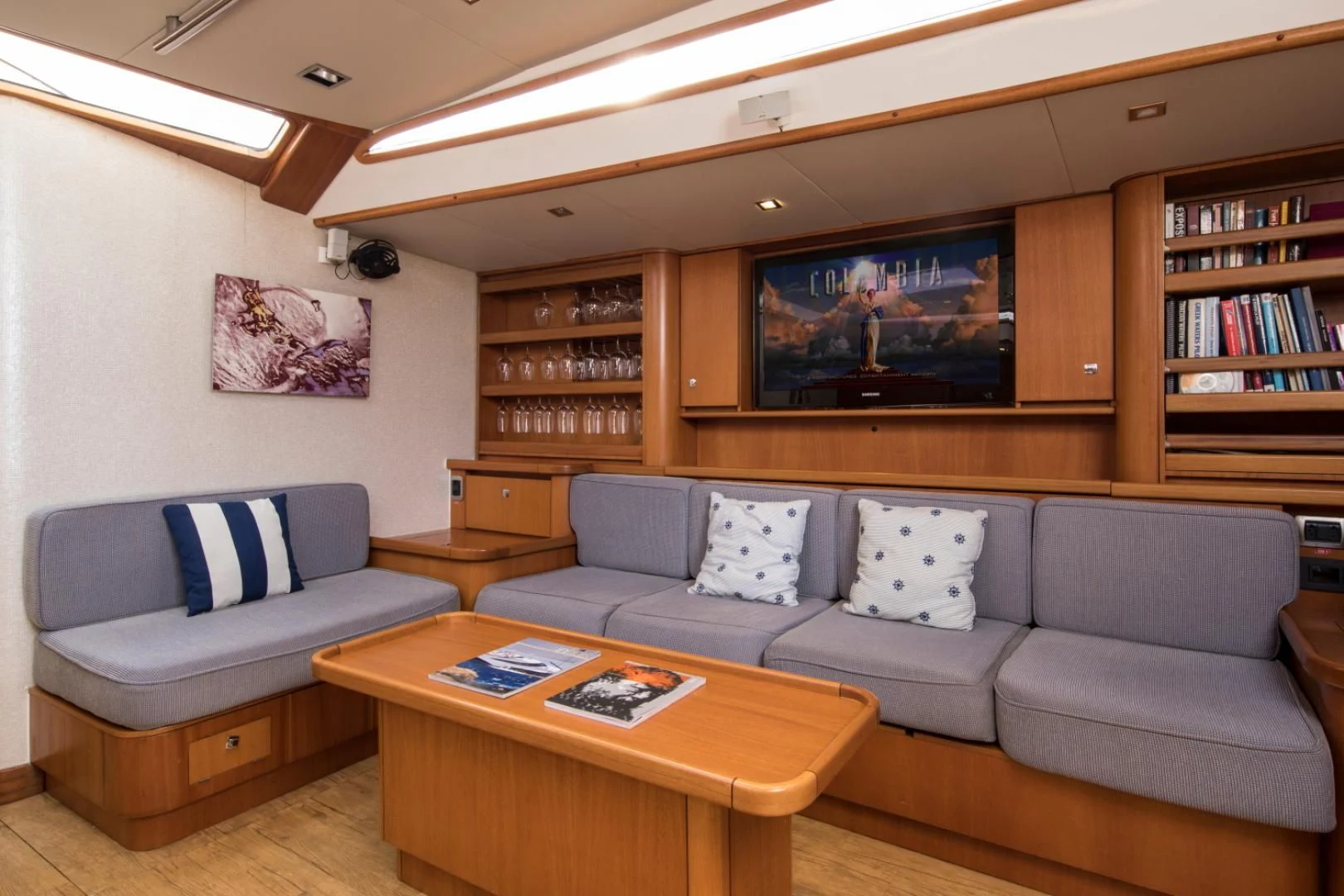 a living room with a couch and a television aboard INDIGO Yacht for Sale