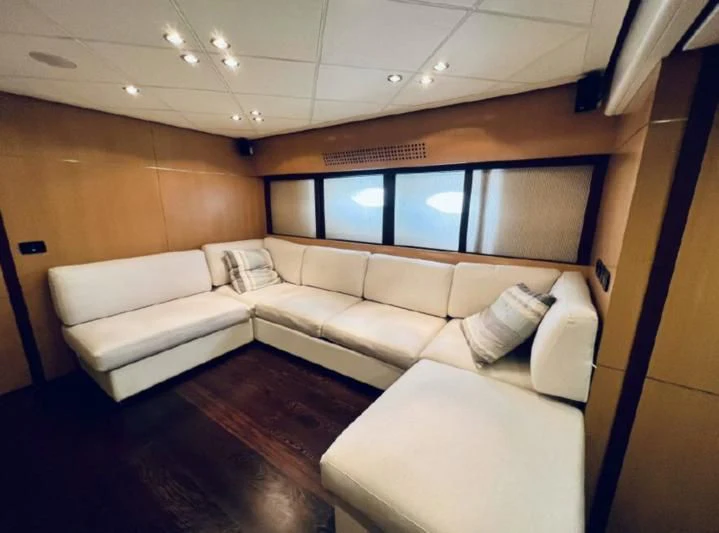 a room with a couch and a television aboard GIGAONE Yacht for Sale
