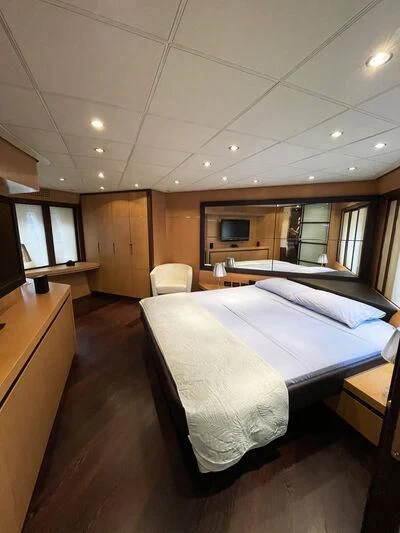 a room with a bed and a chair aboard GIGAONE Yacht for Sale
