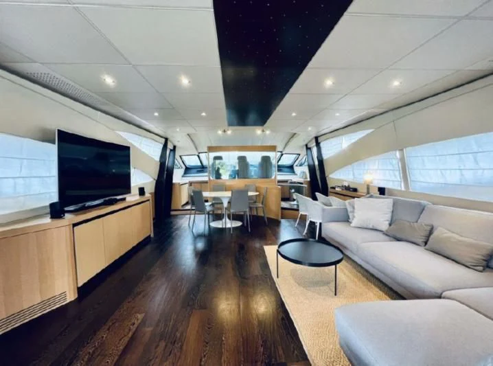 a living room with a wood floor aboard GIGAONE Yacht for Sale