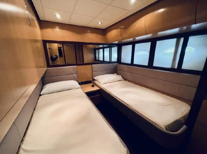 a room with two beds aboard GIGAONE Yacht for Sale
