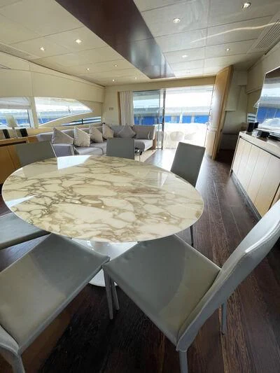 a large table with chairs around it aboard GIGAONE Yacht for Sale